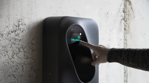 A person using Meridian EV charging Socket