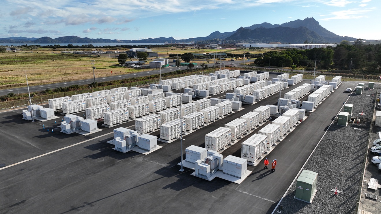 A plot of land with shipping container sized structures making up a grid-scale battery.