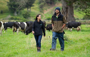 Dairy farmer and a Meridian staff member walking togather