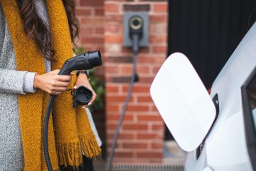 A person charging an EV