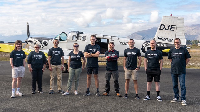 Meridian team by an airplane