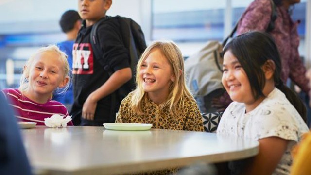 Kids sitting at the table smiling