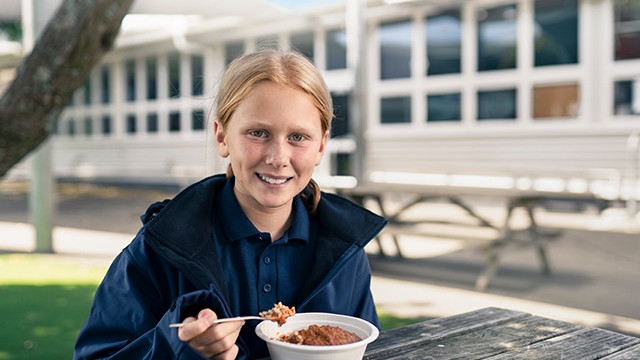 Kid eating school lunch