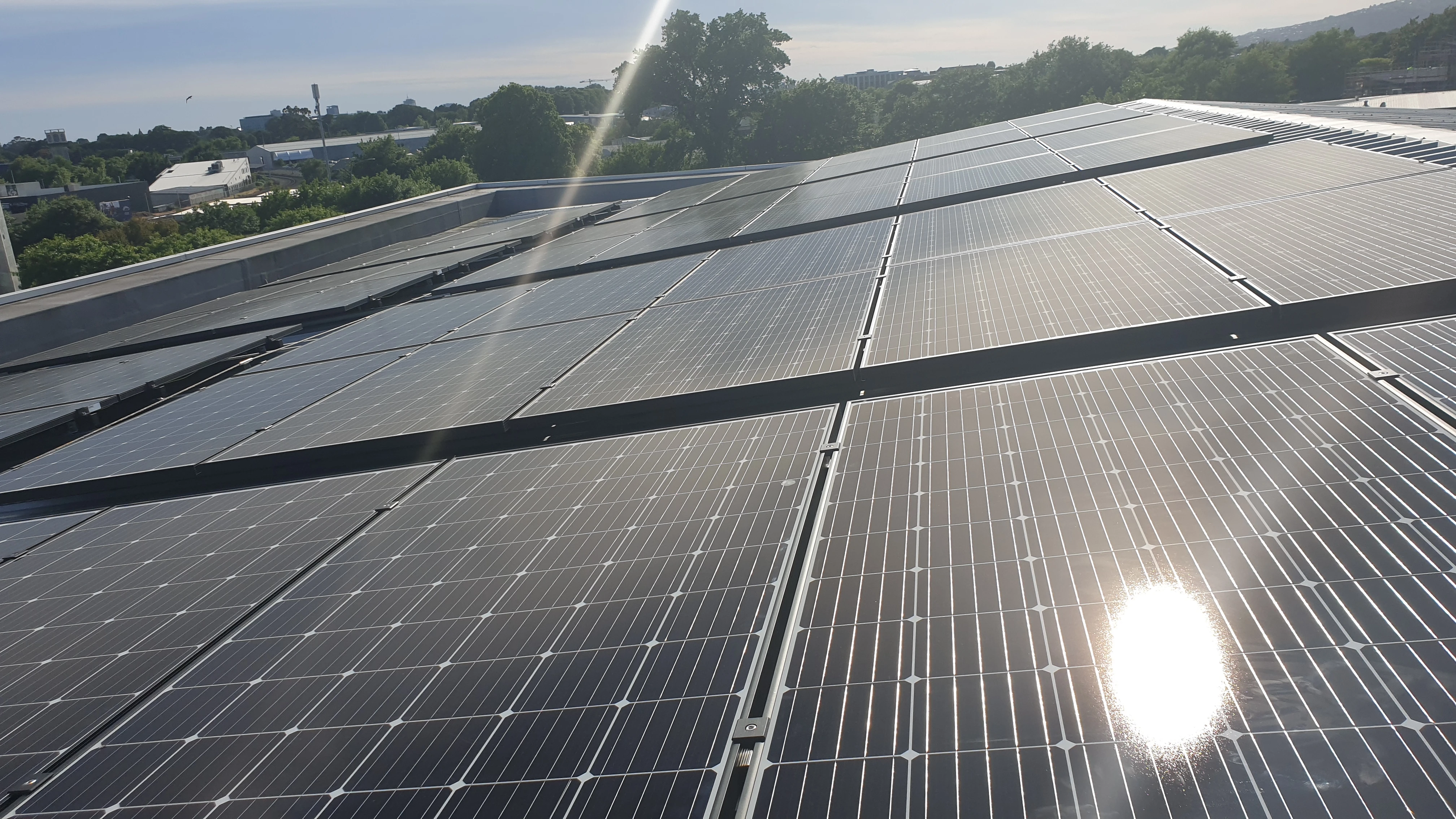 Close up of solar panels arrayed on a roof.
