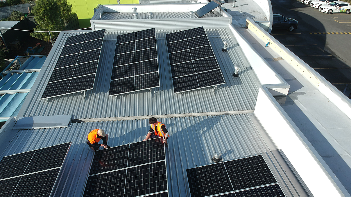 Workers installing solar panels