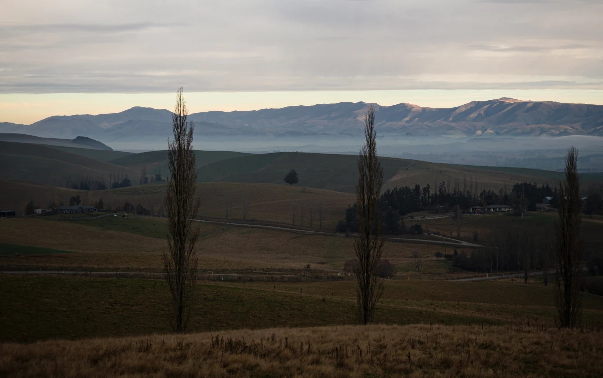 Panorama view of mountain range with low hanging clouds.