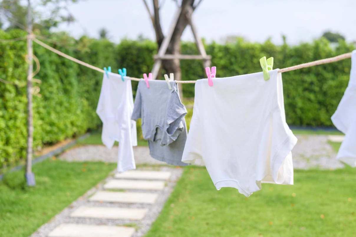 Clothings hanging on a washing machine outside